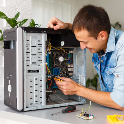 Computer engineer working on broken console in his office